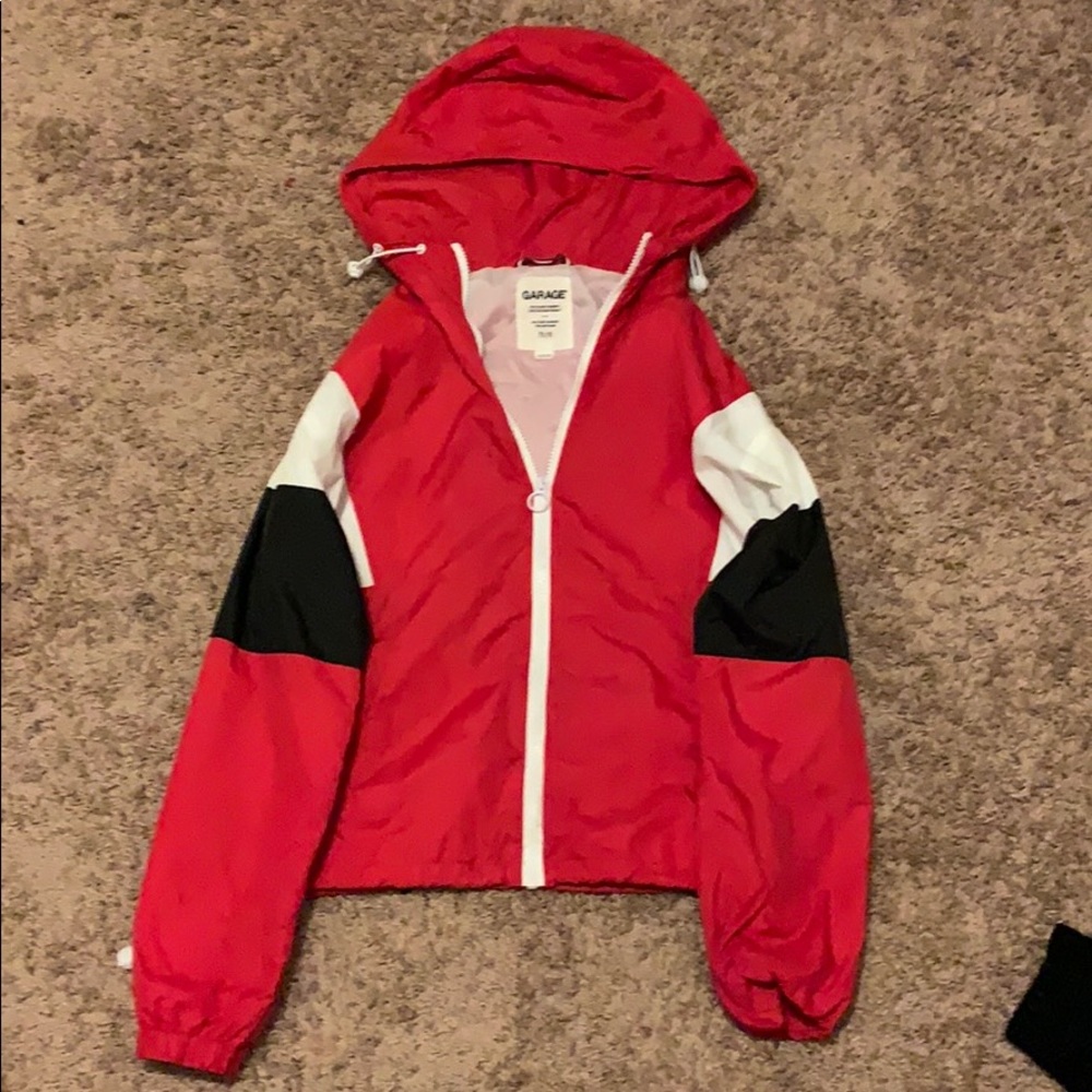 A black white and red jacket with hood and pockets